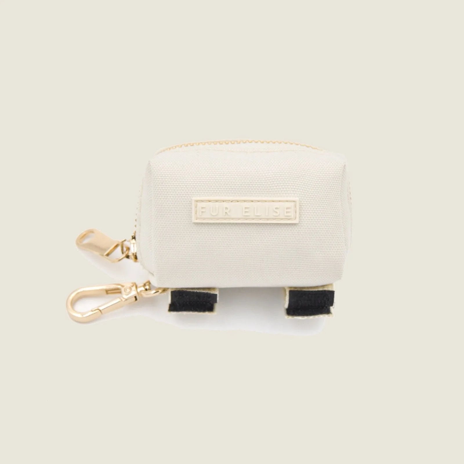 Durable cream fabric poo pouch with gold zipper, lobster claw clasp, and Velcro ties, featuring "FUR ELISE" label.