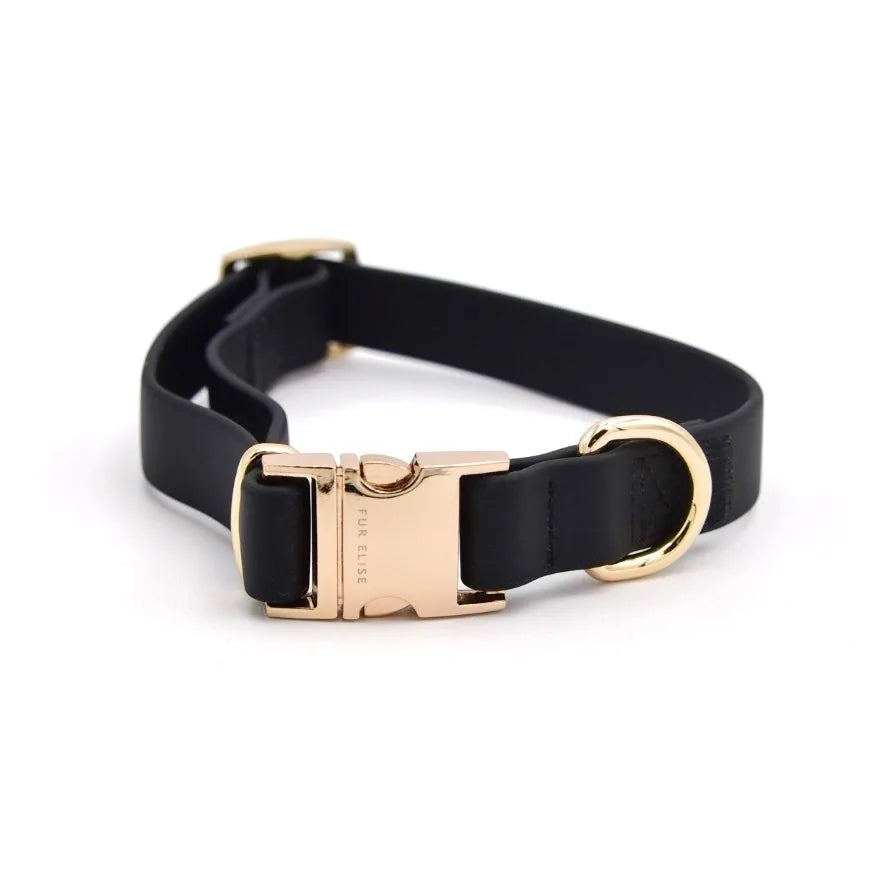 Black dog collar with a gold buckle, featuring a soft rubbery feel and elegant design. Suitable for everyday use.
