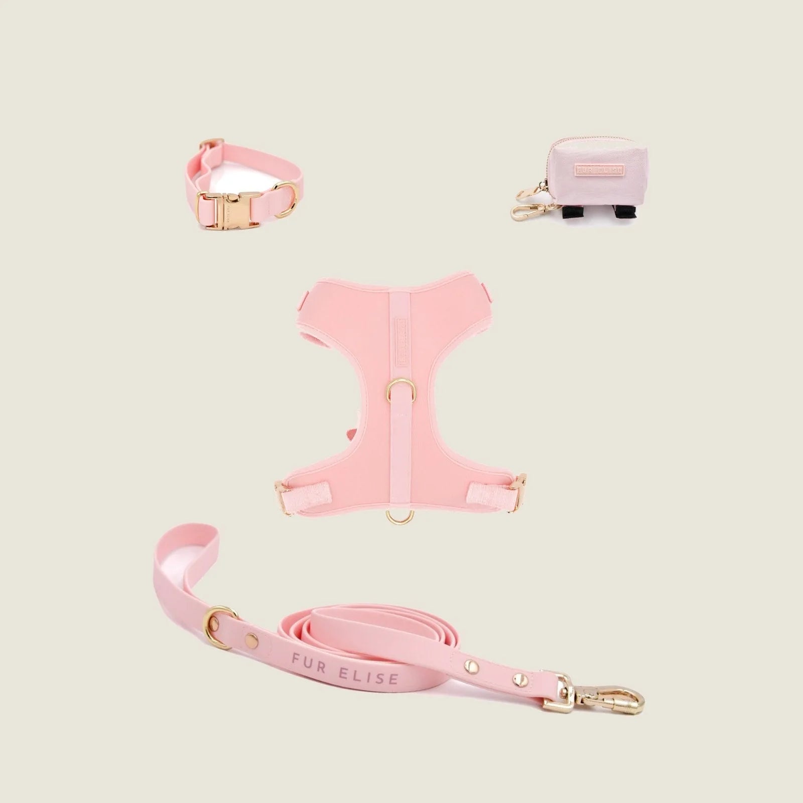 Rose-colored dog walk set featuring a collar, harness, leash with gold accents, and a matching poo pouch.
