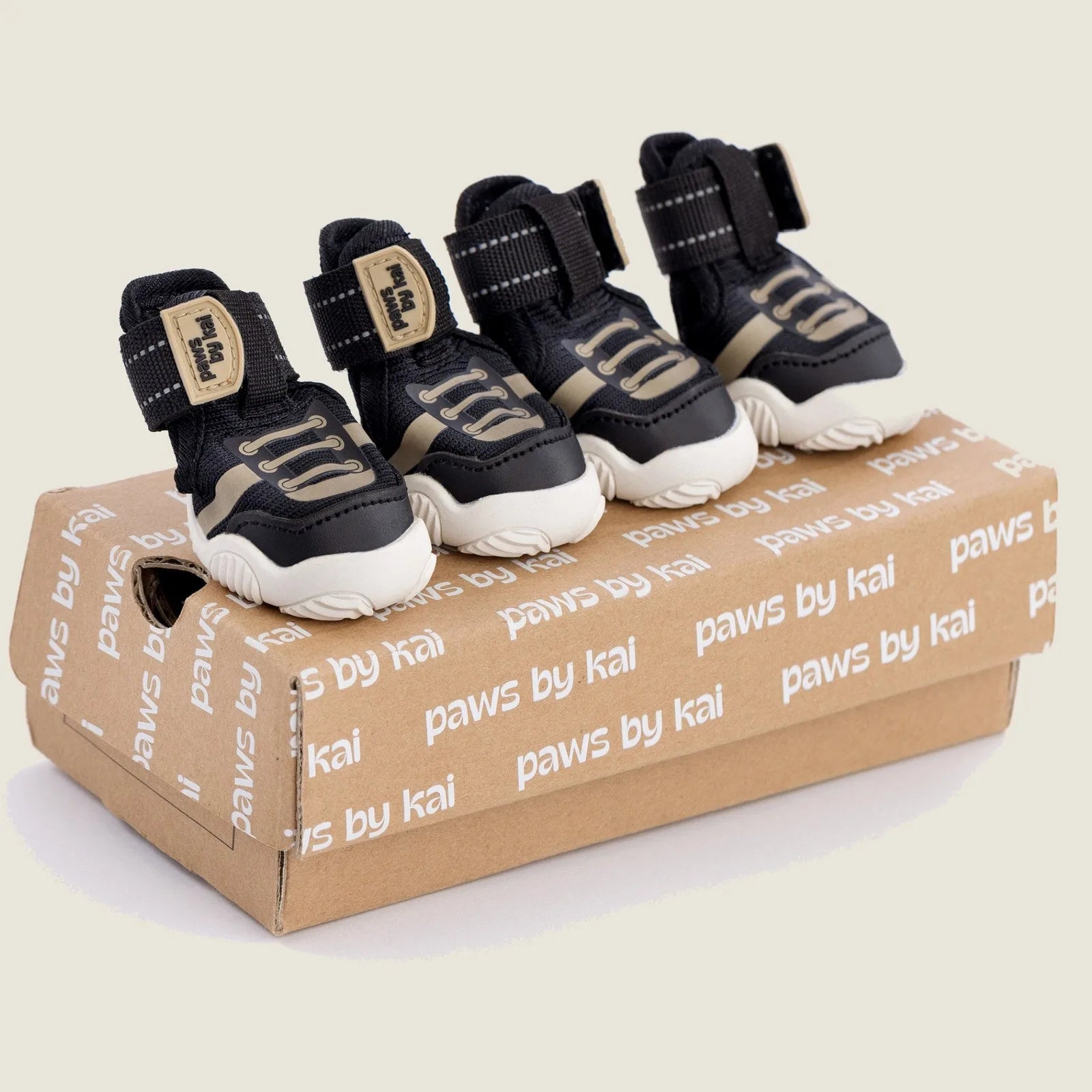 Adjustable black dog sneakers with grip soles on a branded box, designed for comfort and outdoor activities.