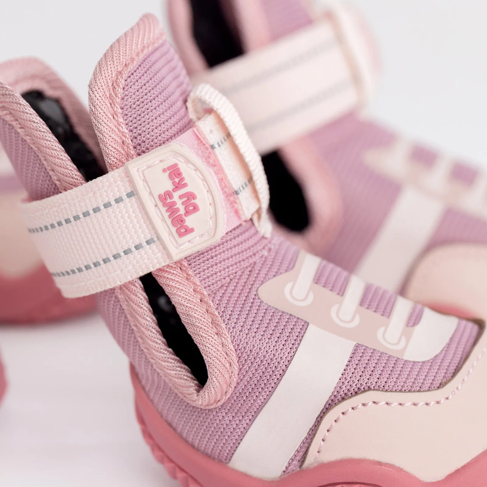 Adjustable pink dog sneakers with a breathable mesh design and grippy soles for outdoor adventures.