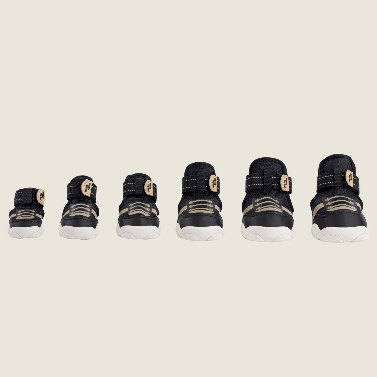 Adjustable black dog sneakers in various sizes with sturdy soles and a stylish design for outdoor activities.