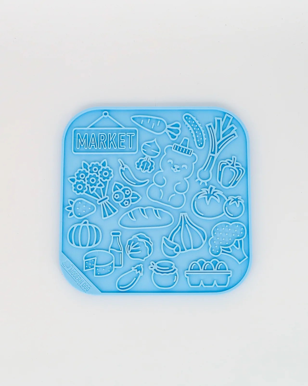 Colorful blue lick mat featuring a farm market theme with various food illustrations and textured designs.