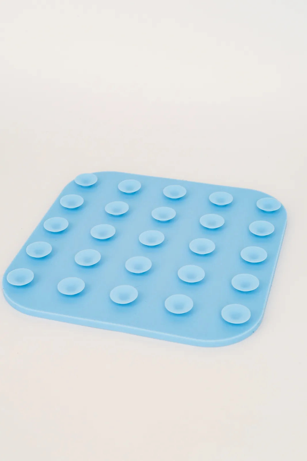 Light blue silicone lick mat with textured surface and suction cups, designed for dog enrichment during snack time.