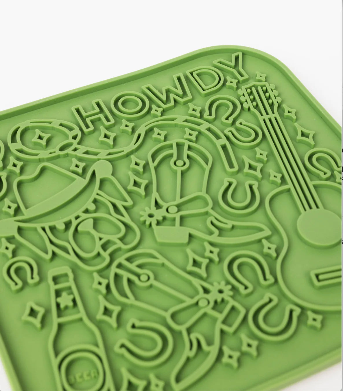 Green silicone lick mat featuring a "Howdy" design with stars, beer bottle, and guitar shapes for engaging dog feeding.