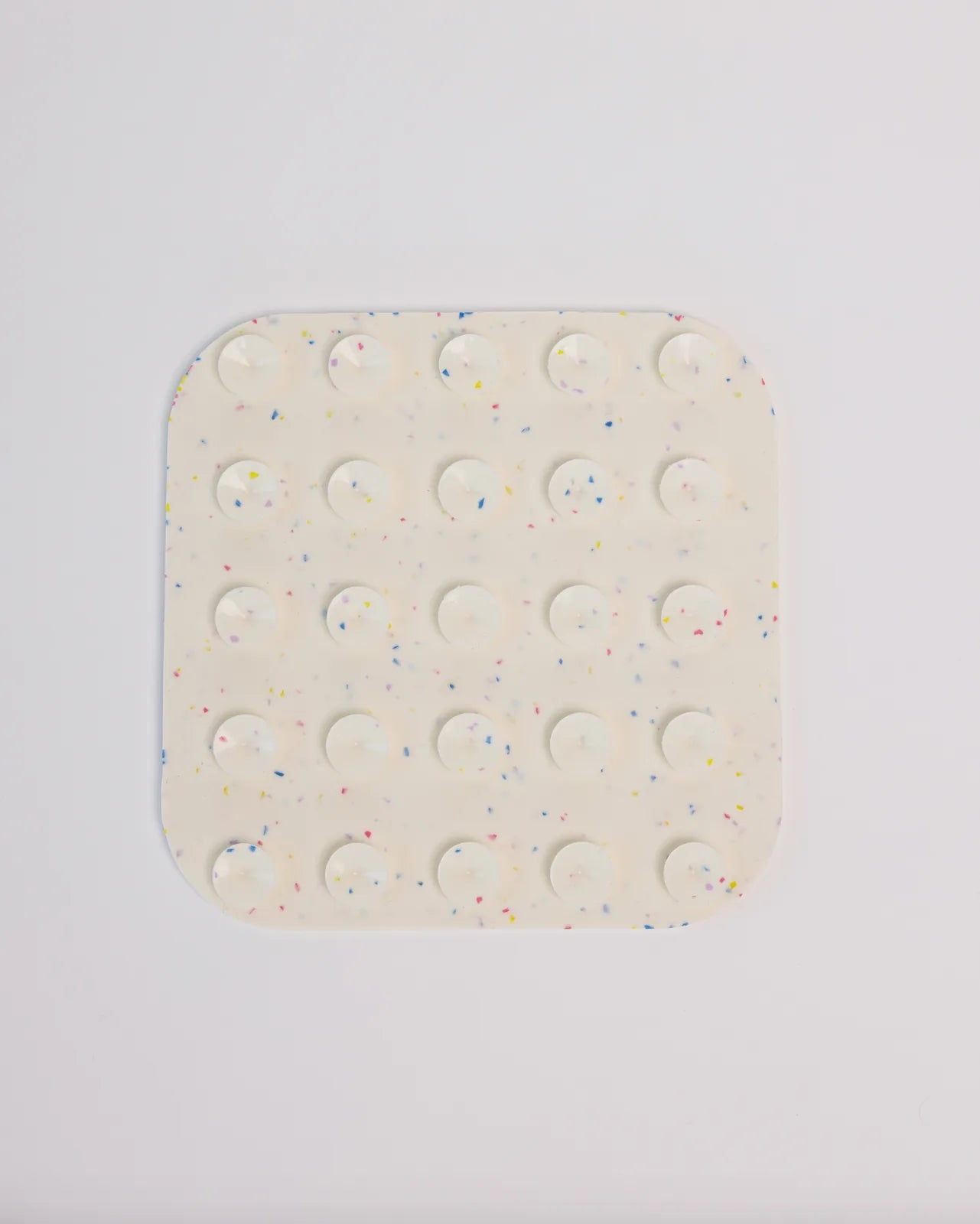 White lick mat with colorful speckles and suction cups, designed for dog feeding and engagement during special occasions.