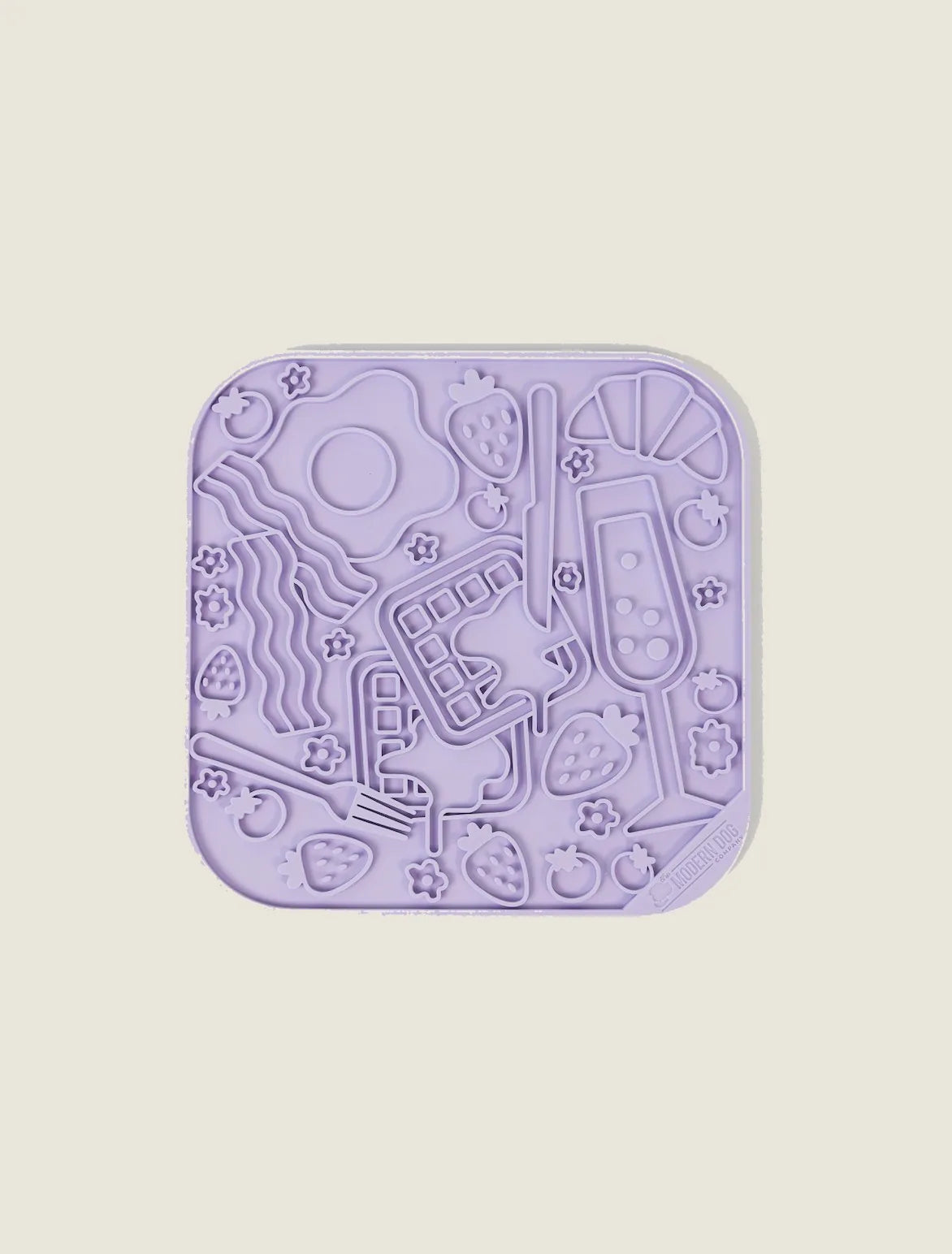 Purple silicone lick mat with playful food-themed textures, designed to engage dogs during treat time.