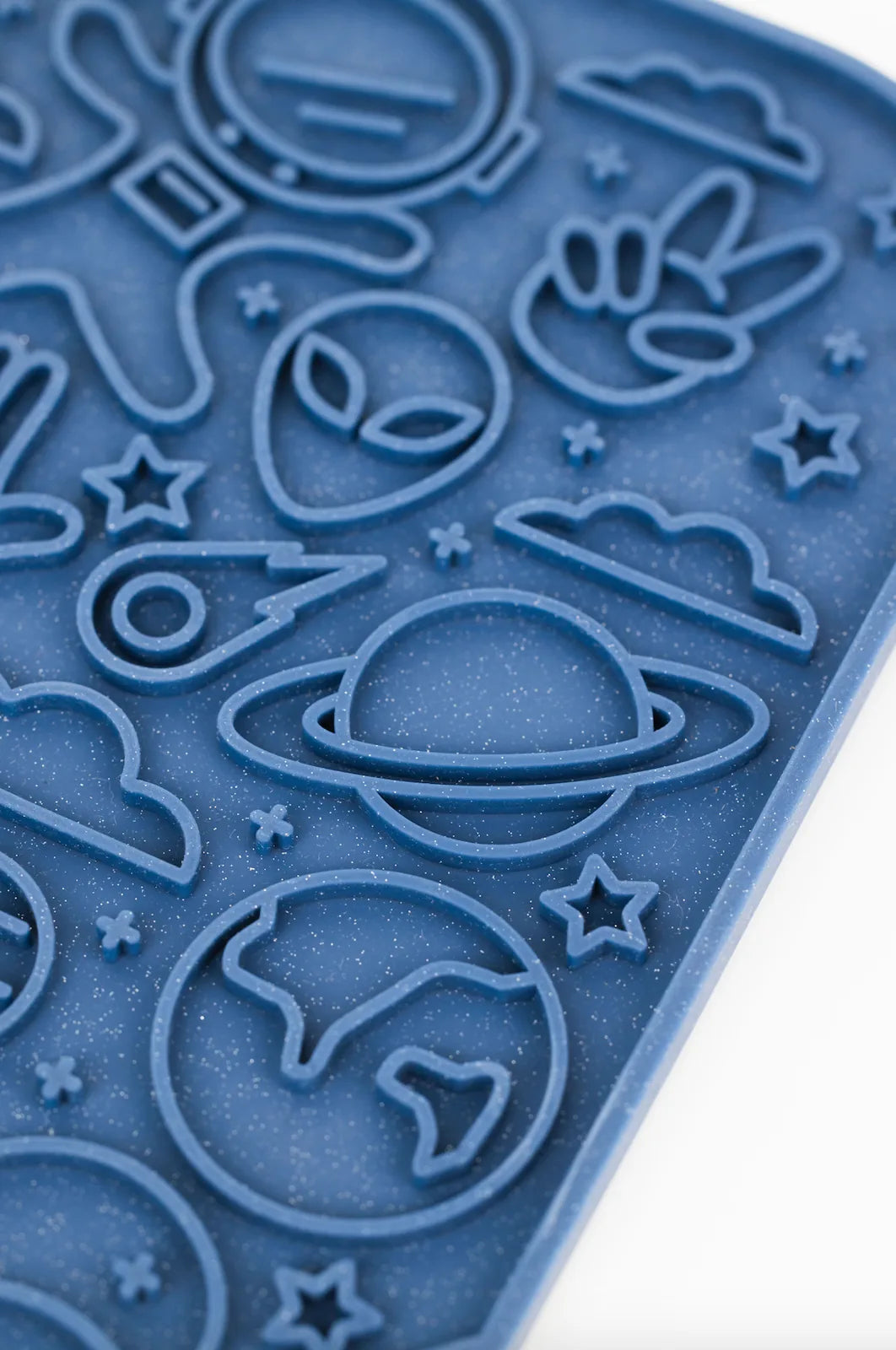 Galaxy-themed blue silicone lick mat featuring designs of planets, stars, and aliens for engaging dog feeding.