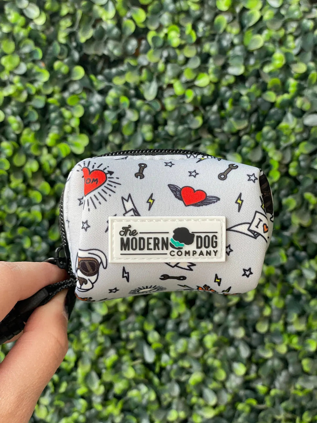 Lightweight neoprene poop bag holder with fun graphics in red and black, featuring "The Modern Dog Company" logo.