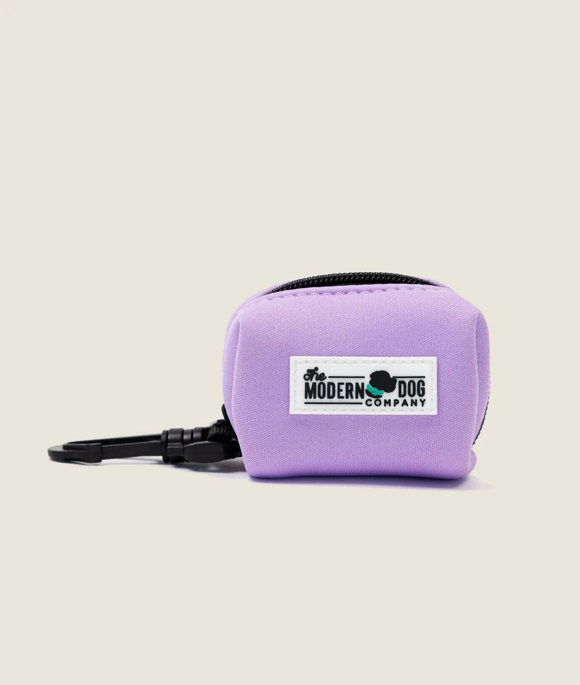 Blush pink neoprene poop bag holder with a clip, featuring The Modern Dog Company logo. Perfect for dog walking convenience.