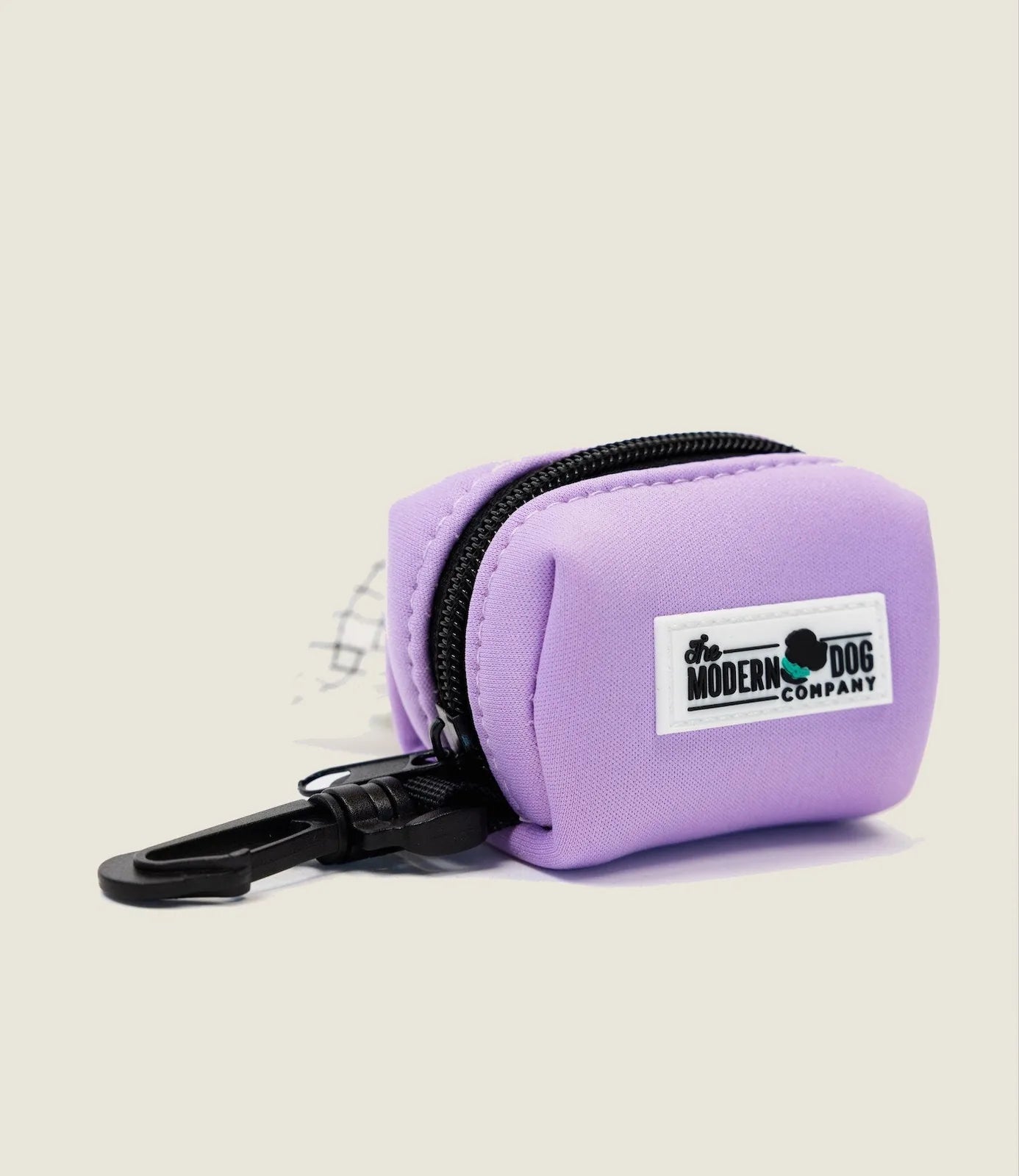 Blush pink neoprene poop bag holder with zip and clip attachment for easy dog walking convenience.