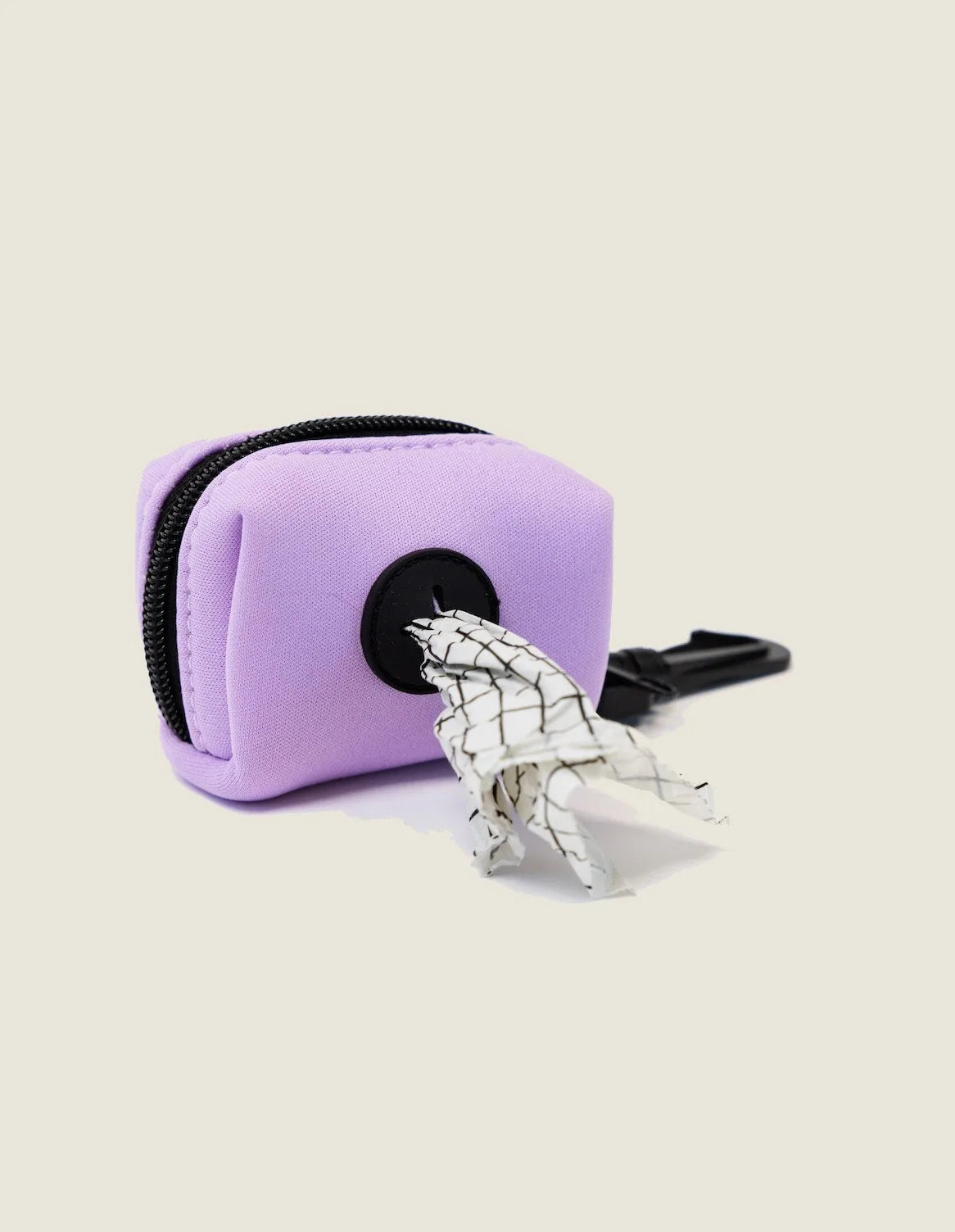 Blush pink neoprene poop bag holder with black zipper and a roll of waste bags peeking out, ideal for dog walks.