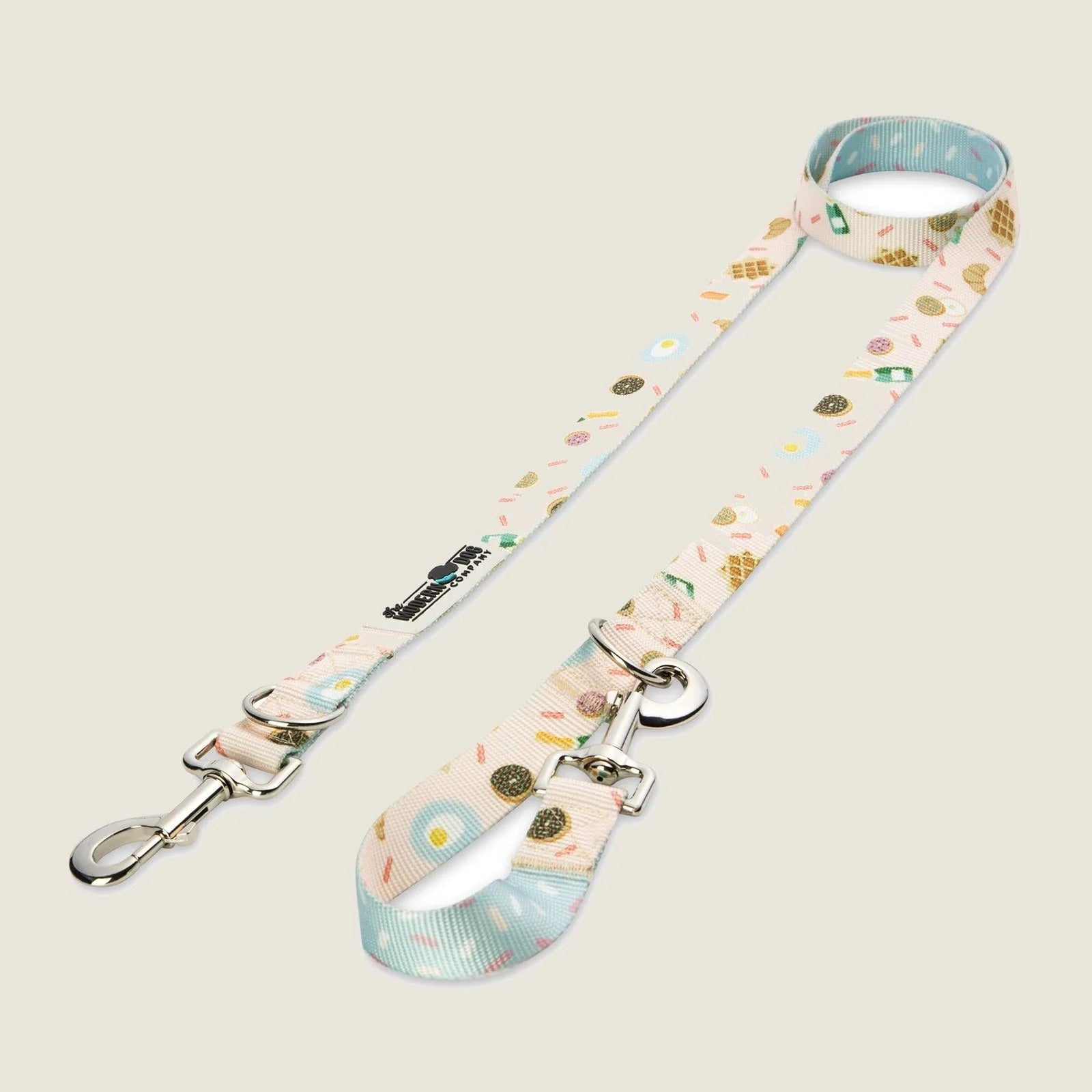 Stylish adjustable dog leash with pastel donut and brunch-themed pattern, featuring dual swivel bolt snaps.