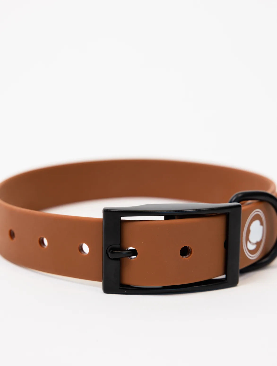 Coco brown adjustable dog collar with a black buckle, featuring holes for size adjustment. Durable and weather resistant.