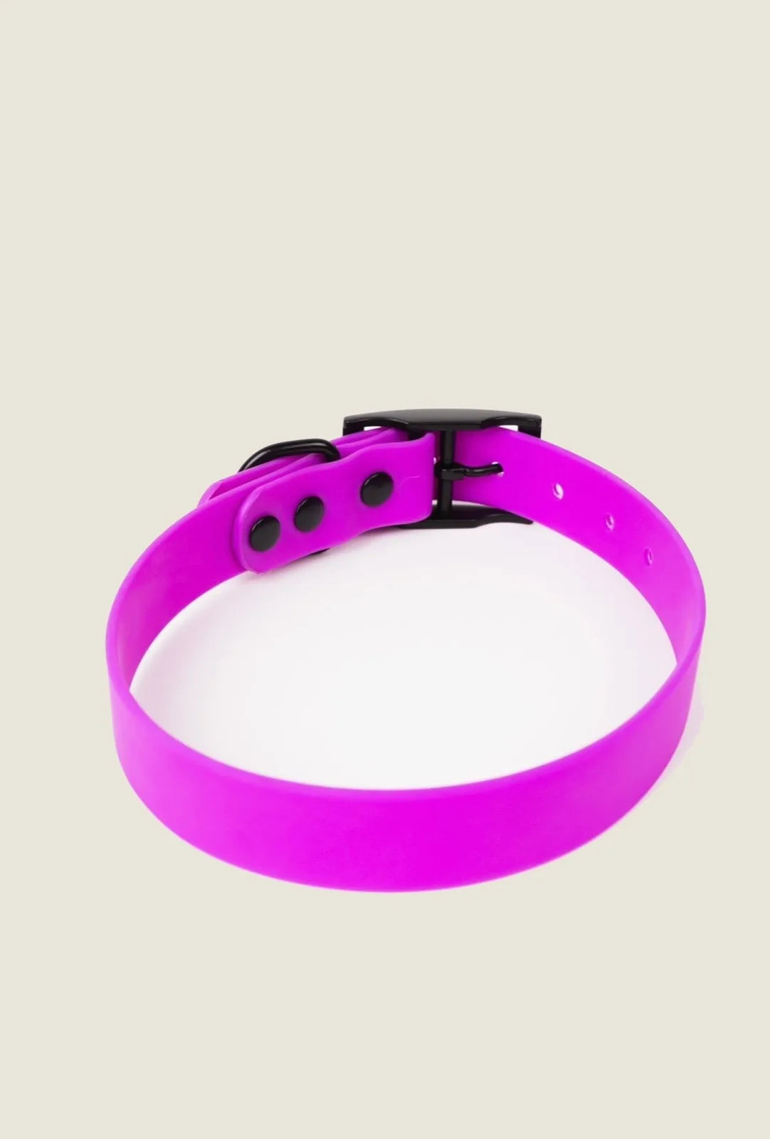 Adjustable electric fuchsia dog collar with a black buckle, designed for all-weather use.
