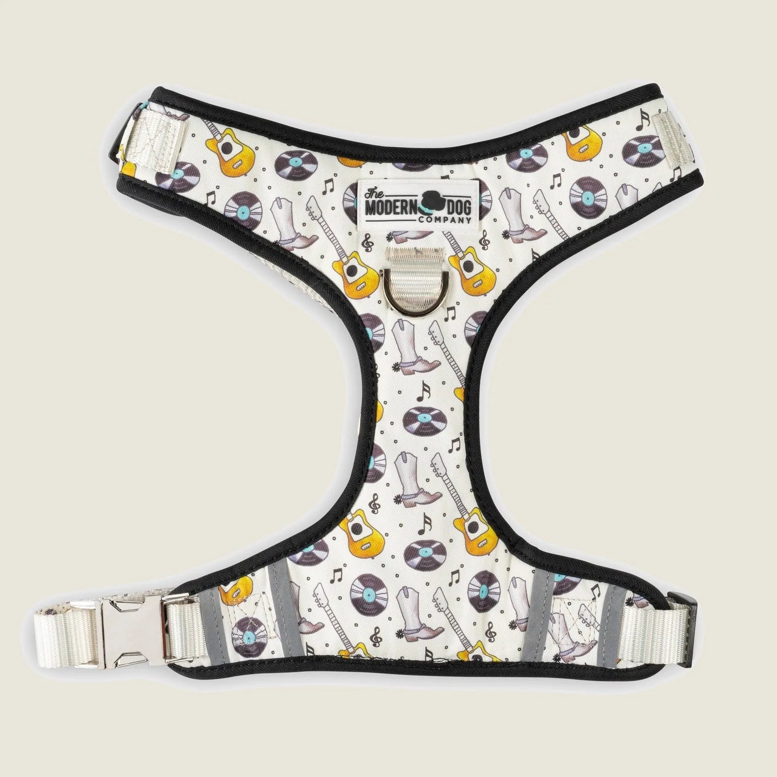 Nashville-inspired dog harness featuring a white fabric with guitars and vinyl records in bright colors.