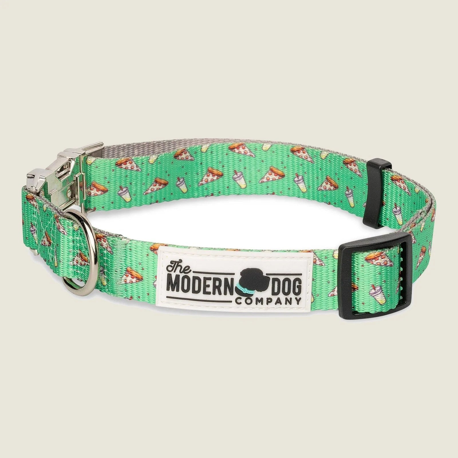 Green dog collar with pizza slice pattern, featuring adjustable strap and all-metal buckles from The Modern Dog Company.