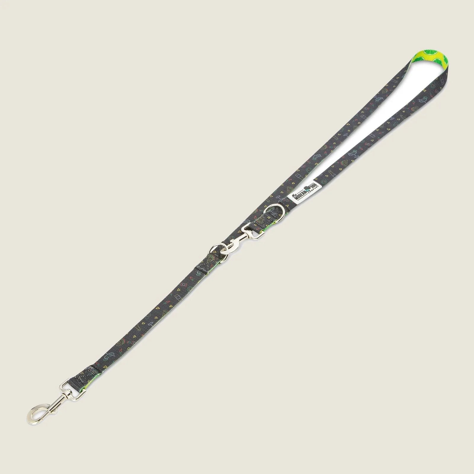Retro Taco Tuesday dog leash featuring a playful black pattern with colorful taco designs and a neon green handle.