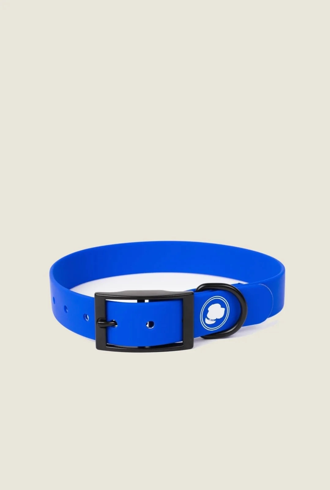Royal blue adjustable dog collar with a black buckle and logo, designed for everyday use and outdoor adventures.