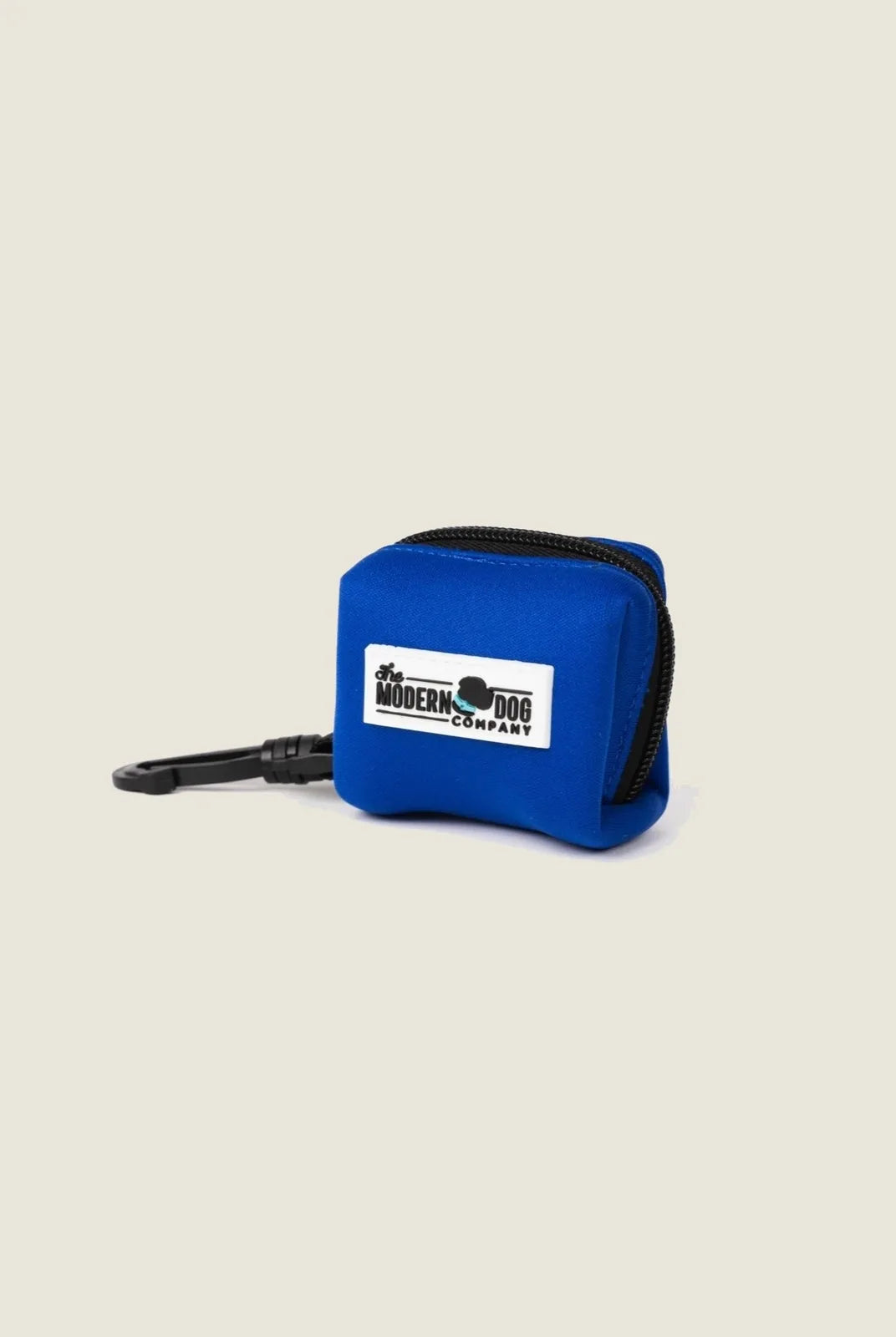Royal Blue neoprene poop bag holder with a black clip, featuring The Modern Dog Company logo on a white patch.