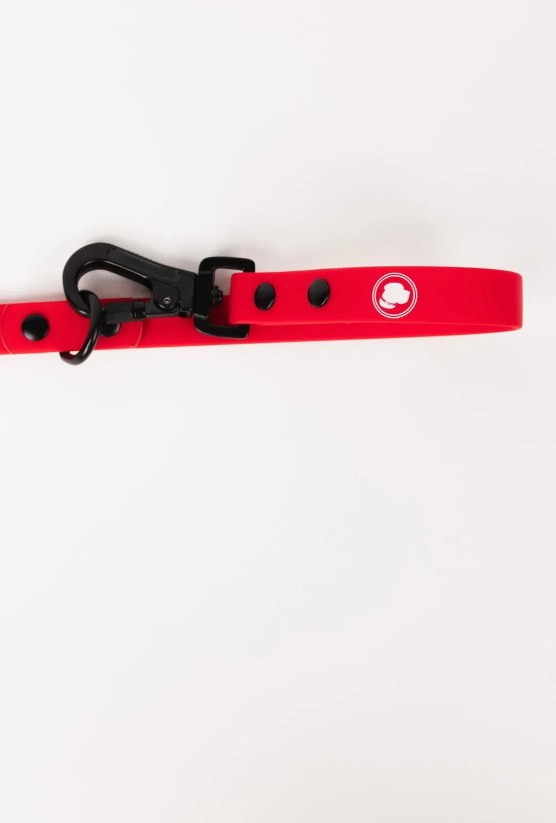 Adjustable Ruby Red dog leash with black hardware and logo, made for all-weather durability and easy cleaning.