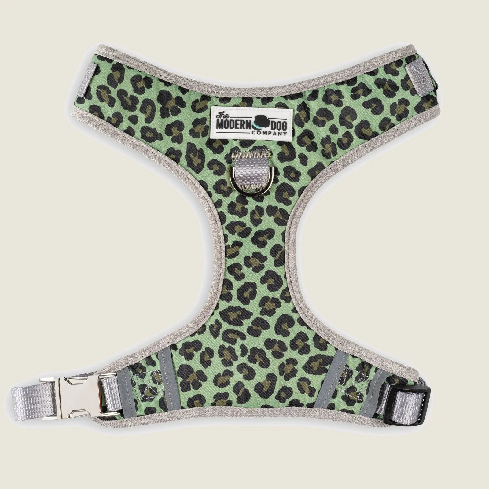 Green leopard print dog harness featuring adjustable straps and double D-ring attachment for versatile use.