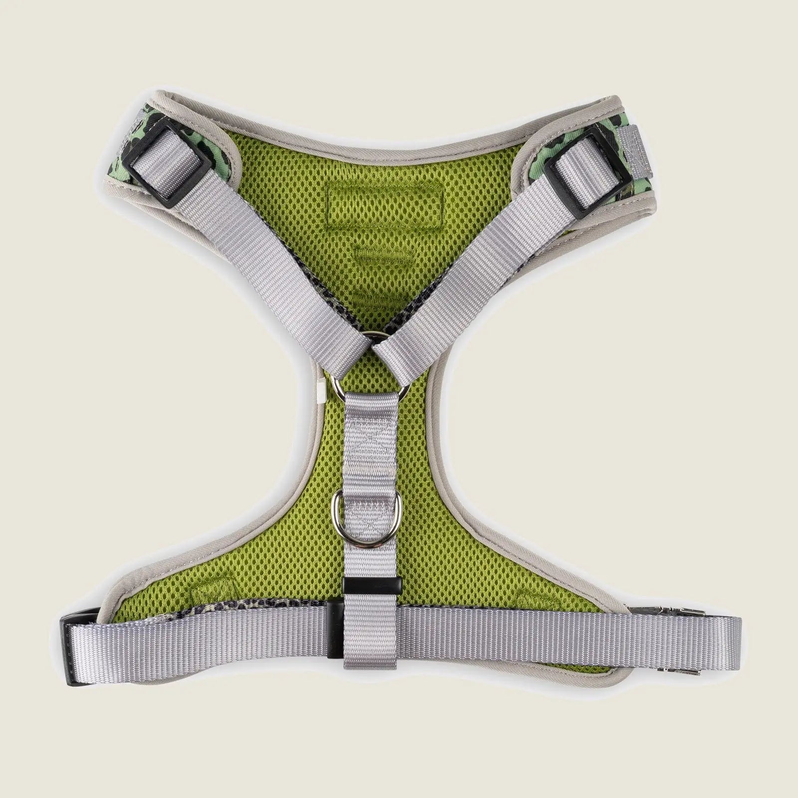 Adjustable dog harness featuring a breathable green mesh design with silver straps and double D-ring attachment points.