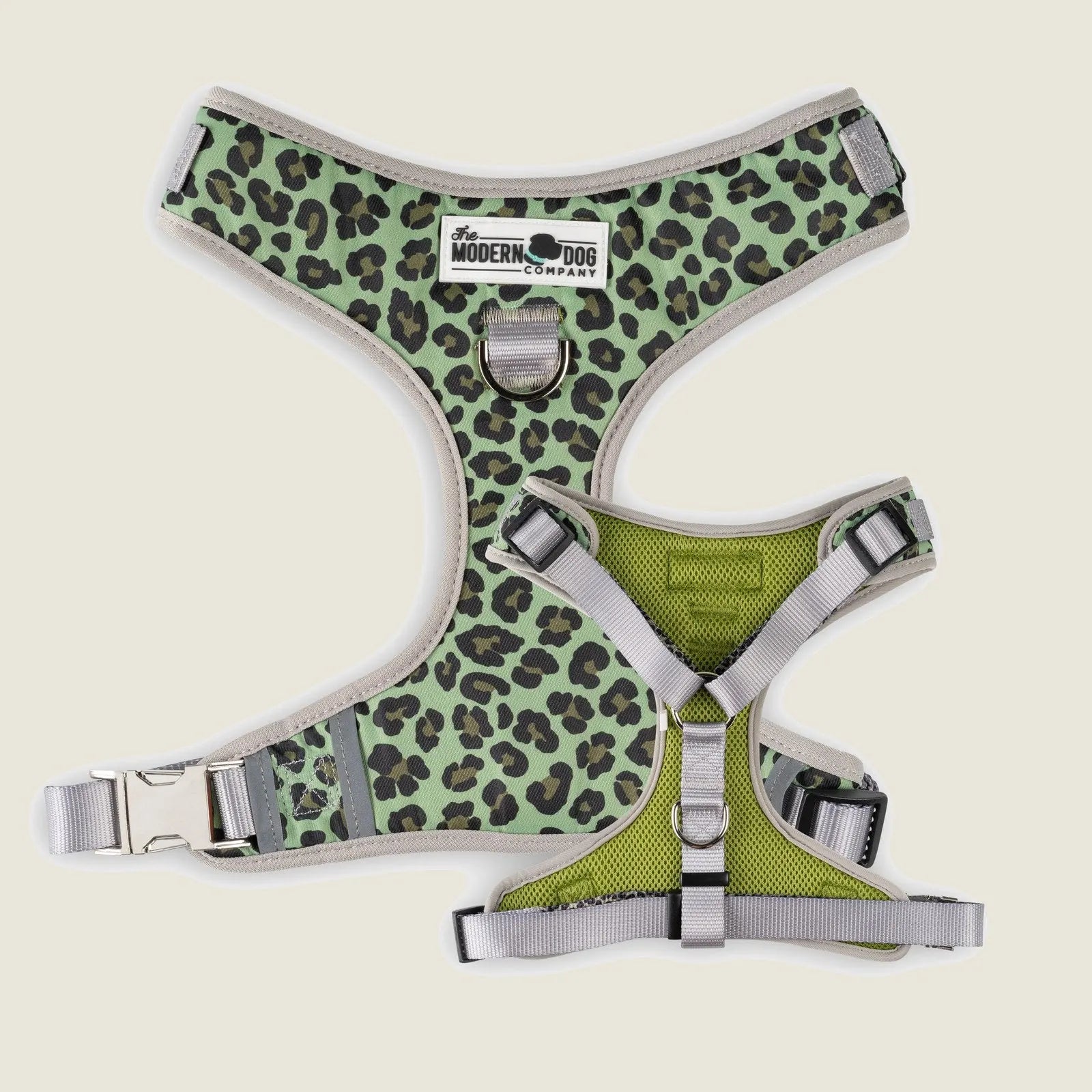 Green leopard print dog harness with adjustable straps and double D-ring design for leash attachment.