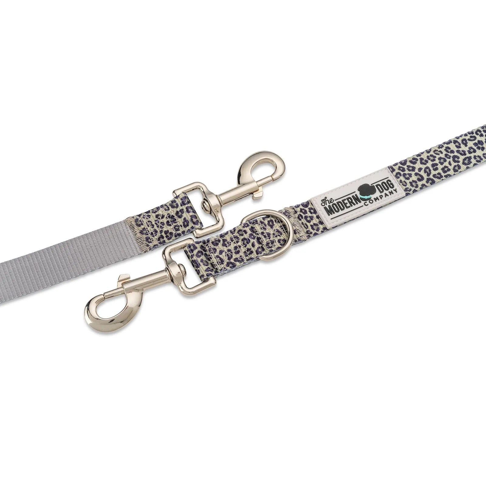 Leopard print dog leash featuring dual swivel bolt snaps and multiple D-ring attachment points for accessories.