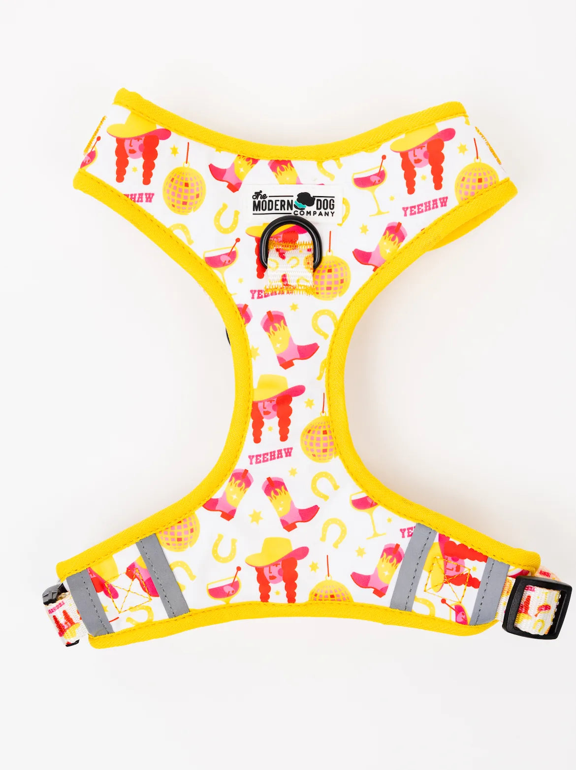 Stylish white dog harness with a colorful Yeehaw pattern, yellow trim, and double D-ring design for leash attachment.