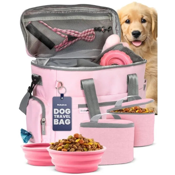 Pink collapsible bowls, insulated containers, and a travel bag are organized, with a golden retriever puppy in the backgro...