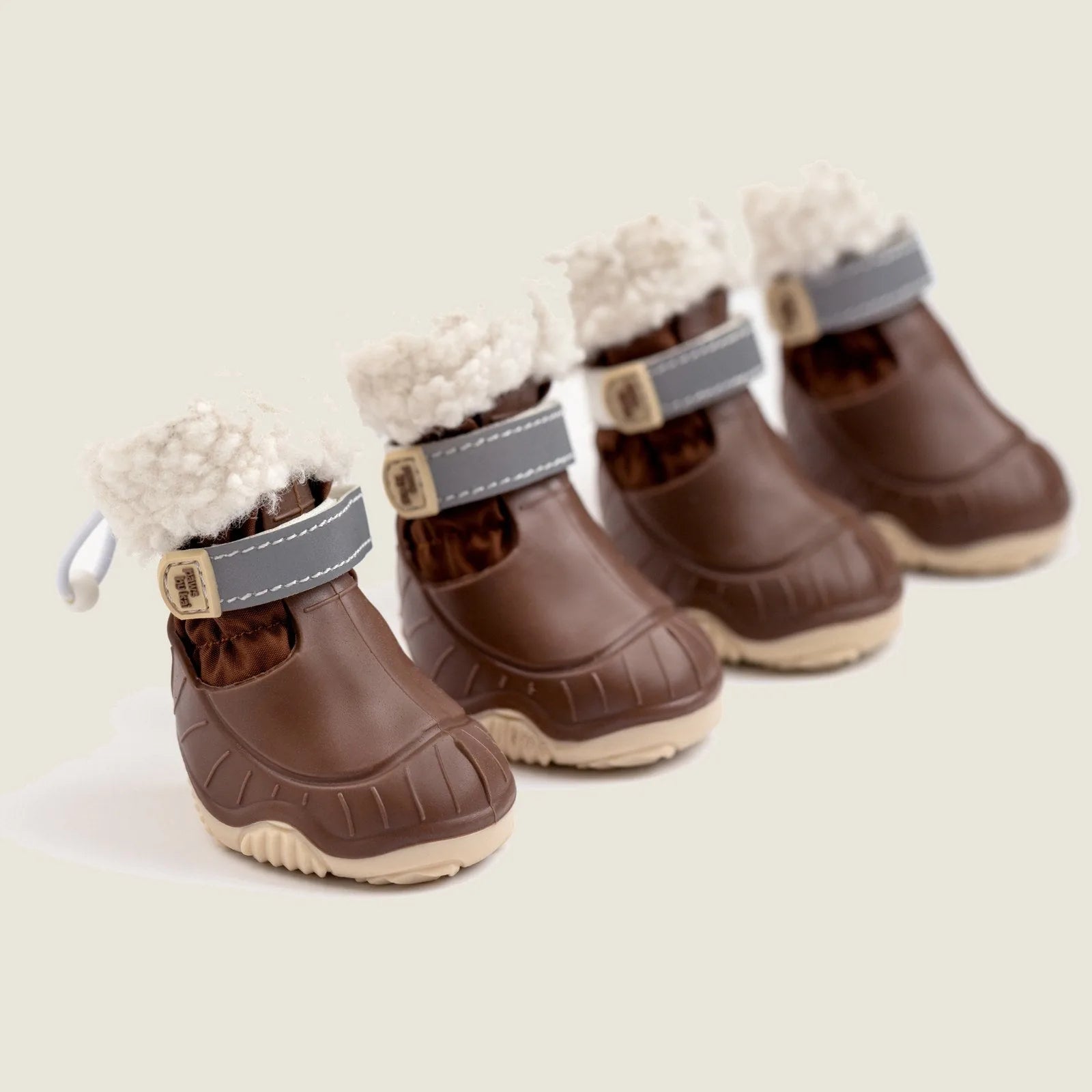 Brown waterproof dog snow boots with sherpa lining and adjustable straps, perfect for winter walks.