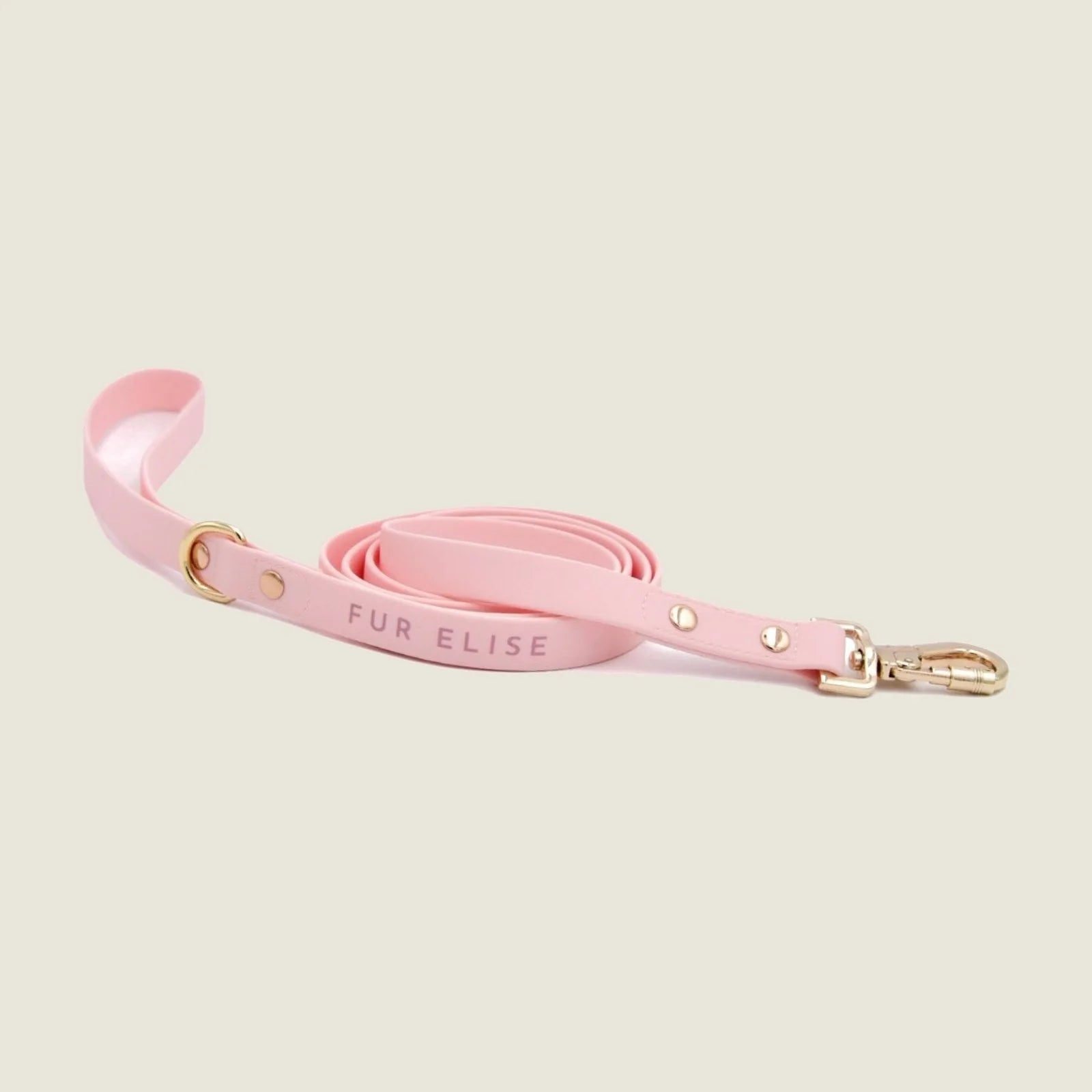 Soft pink leash with gold hardware, featuring "FUR ELISE" text, perfect for stylish dog walking adventures.