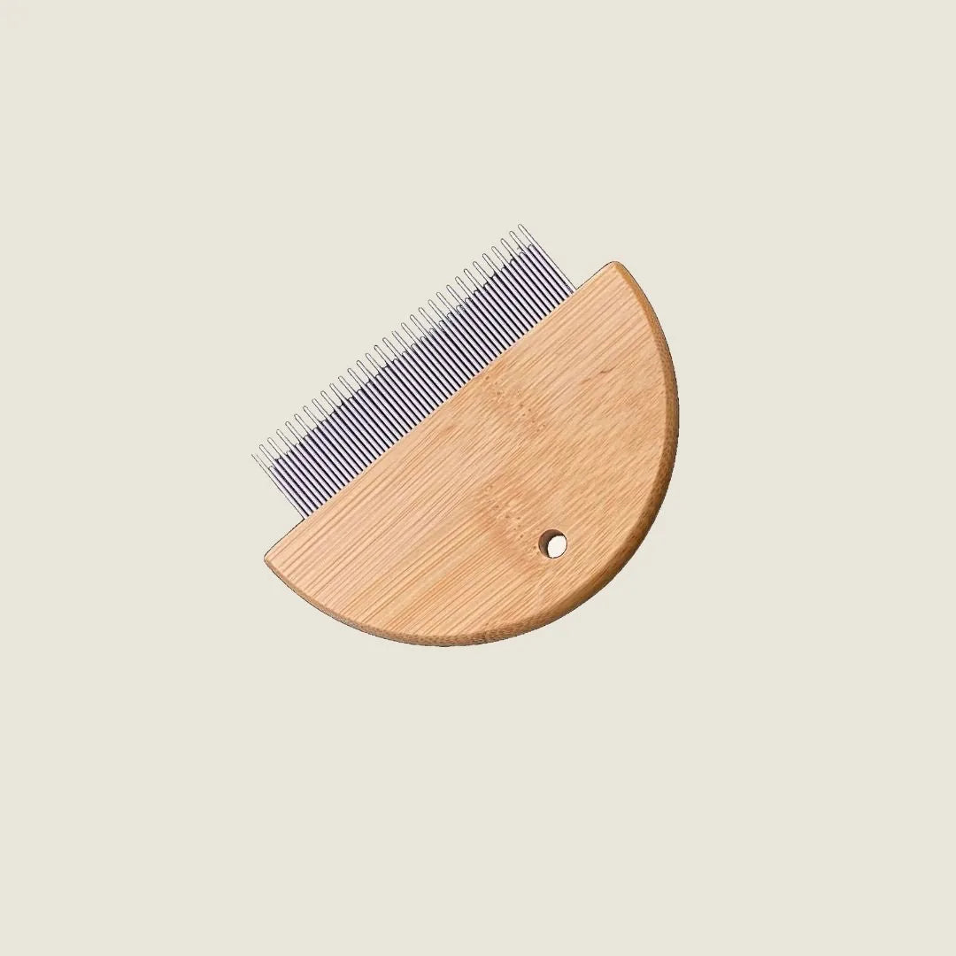 Bamboo flea detangler comb with a rounded wooden handle and fine metal teeth for gentle grooming of pets.