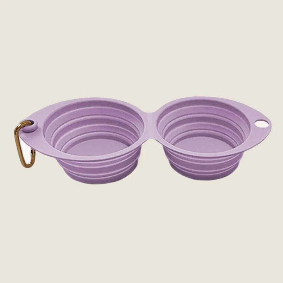 Collapsible double pet bowl in lilac, featuring a clip for easy attachment, ideal for travel and outdoor feeding.