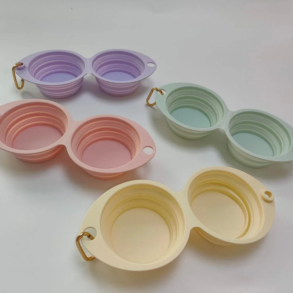 Collapsible double pet bowl set in pastel colors: lilac, pink, mint green, and banana, made for travel convenience.