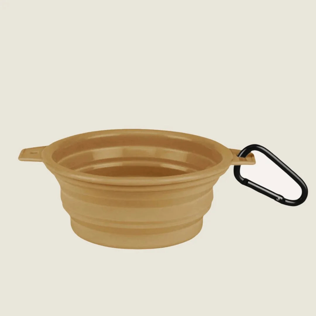 Collapsible sandstone dog bowl with a clip for easy attachment, designed for travel and outdoor feeding.