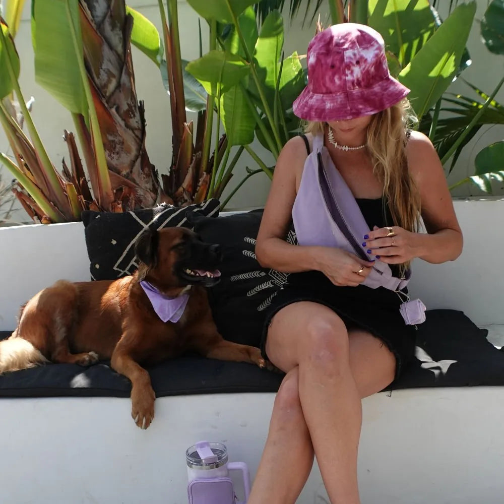Compact lilac pet bowl next to a woman and her dog, highlighting travel-friendly feeding solutions.