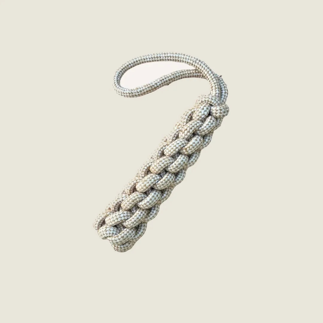 Beige braided hemp rope tug toy with a loop handle, designed for durable play and chewing sessions.