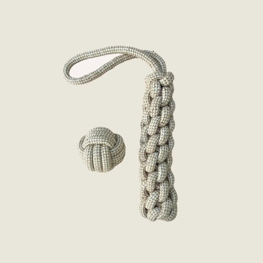 Durable, natural hemp rope tug toy with a braided handle and a knotted ball for interactive dog play.