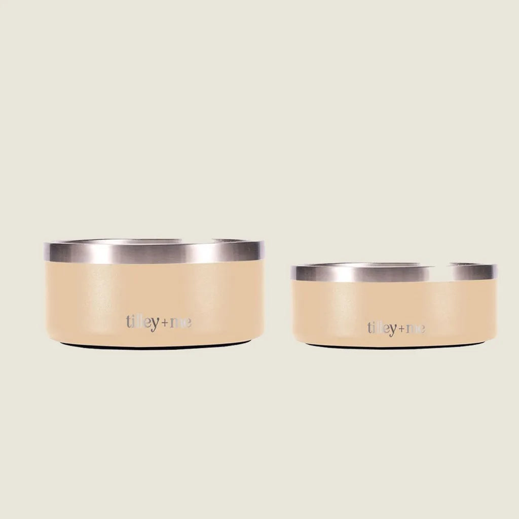 Stainless steel pet bowls in a soft cream color with a non-slip base, available in two sizes from Tilley + Me.