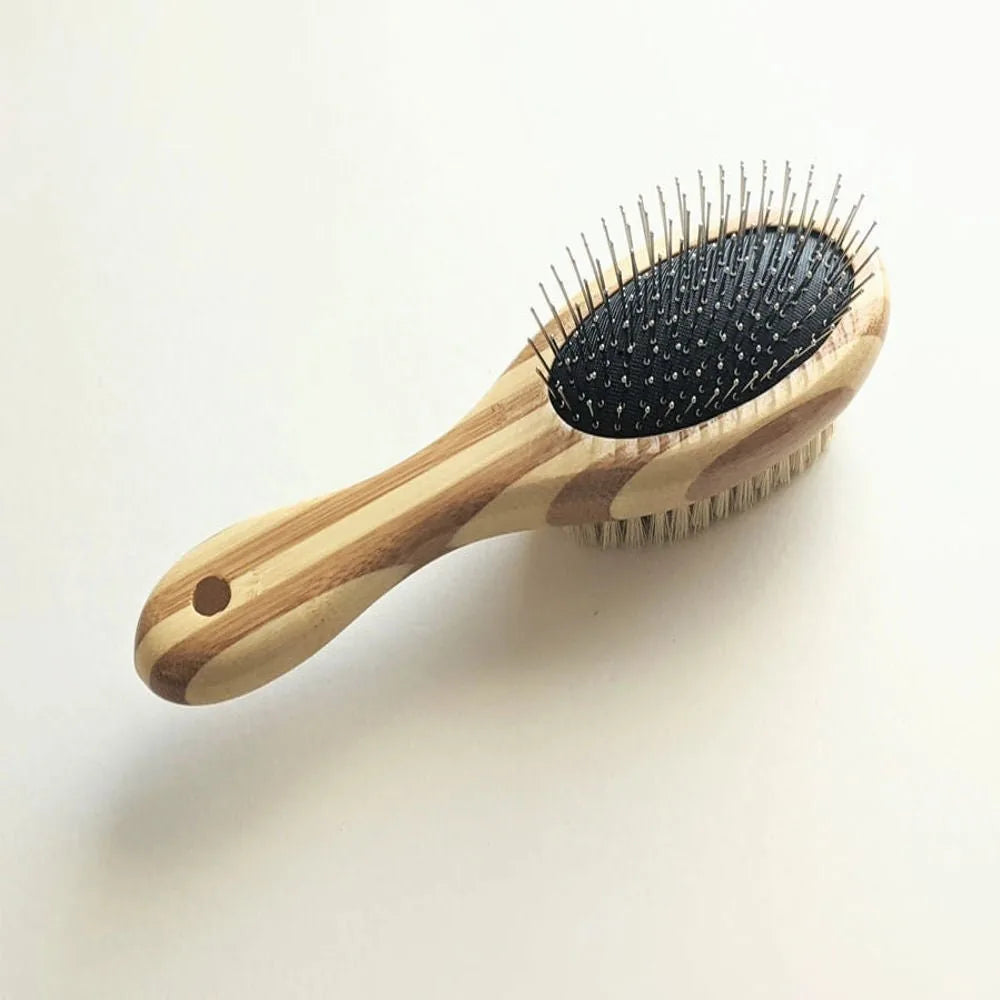 Two-sided pet brush with bamboo handle, featuring fine wire pins on one side and natural bristles on the other.