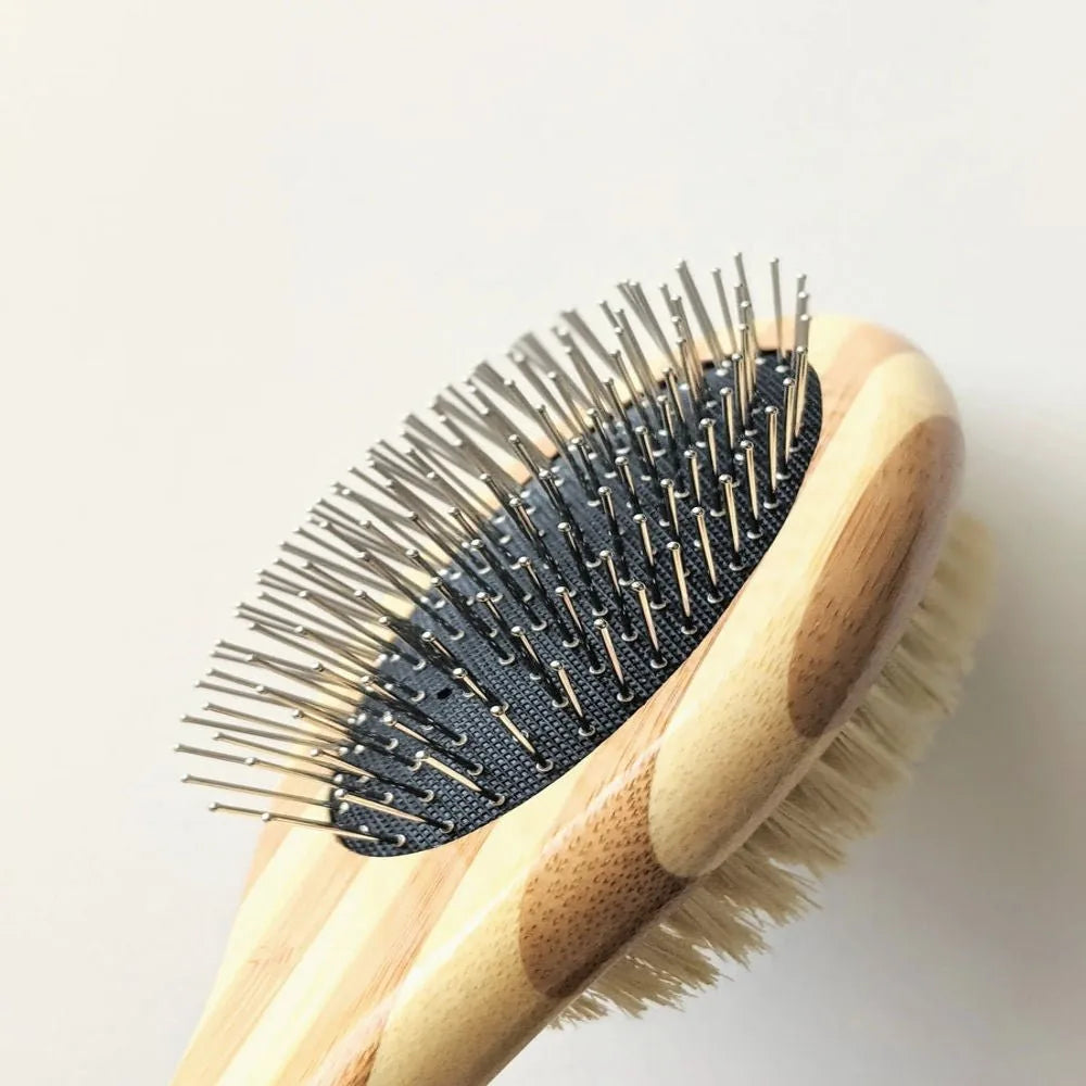 Two-sided pet brush with natural bristles and fine wire pins, featuring a bamboo handle for comfortable grooming.