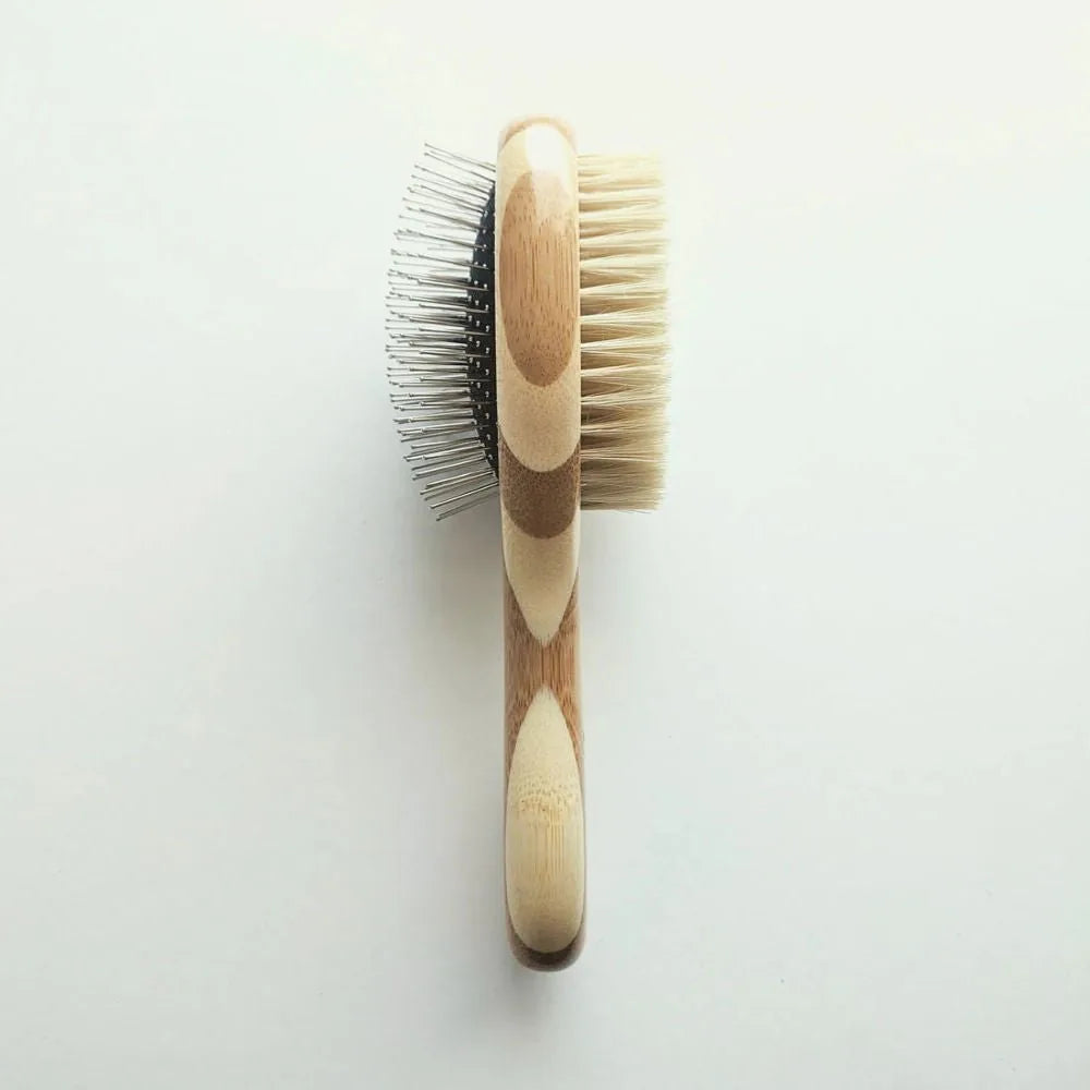 Two-sided pet brush with bamboo handle; one side features natural bristles, the other fine wire pins for grooming.
