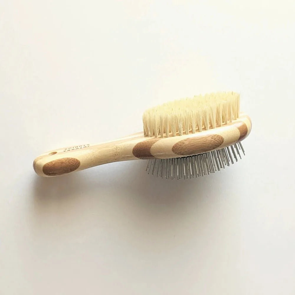 Two-sided pet brush featuring natural bristles and fine wire pins, with a bamboo handle for comfortable grooming.