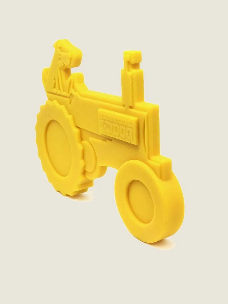 Durable yellow tractor-shaped nylon chew toy for aggressive dogs, featuring a fun design and textured surface.