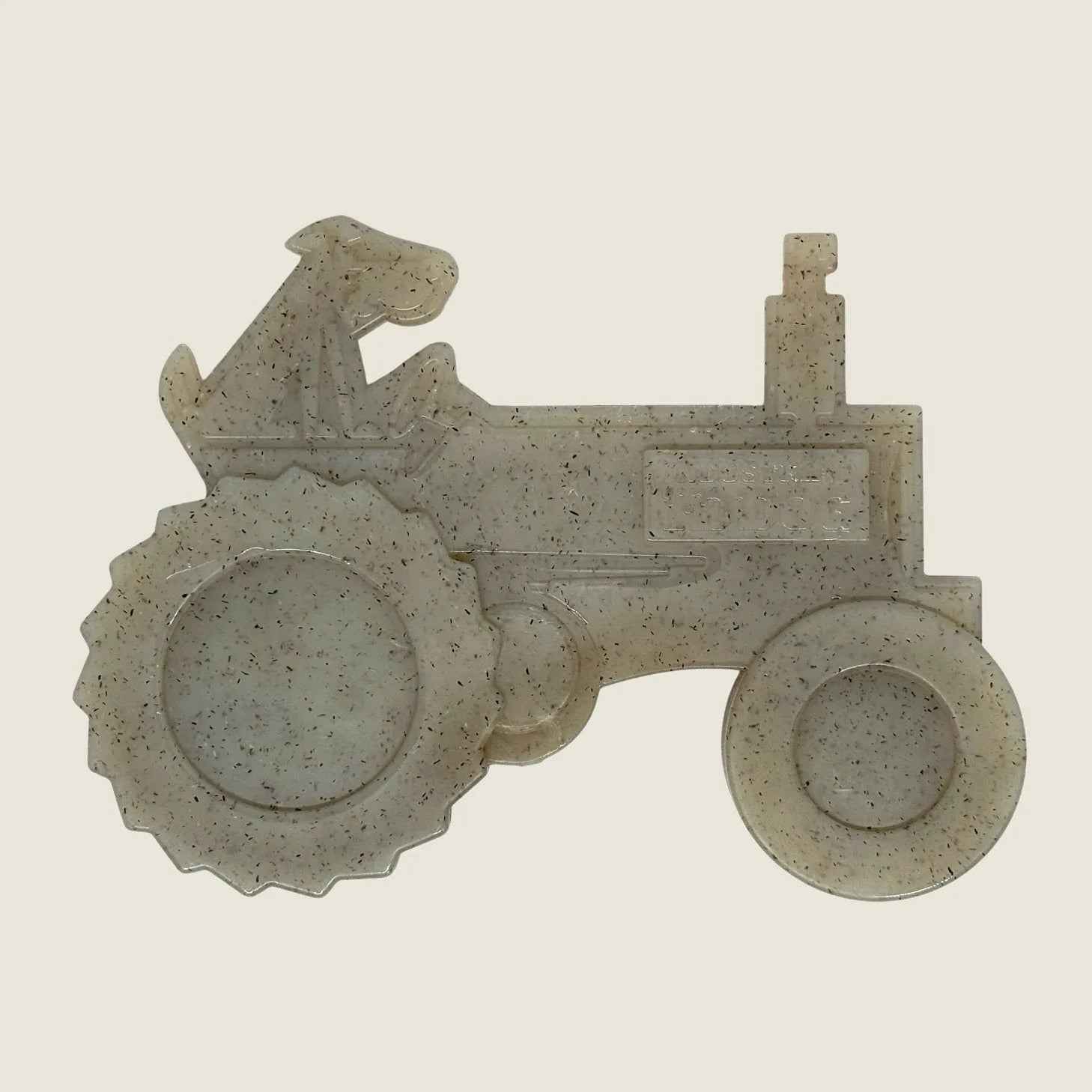 Tractor-shaped chew toy made of durable, non-toxic nylon in a light speckled color, ideal for aggressive chewers.