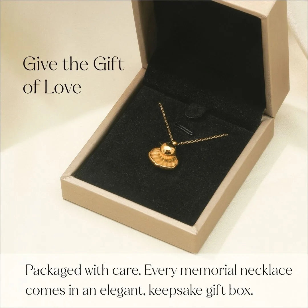 Gold treasure cremation necklace resting in a black velvet-lined gift box, symbolizing love and cherished memories.