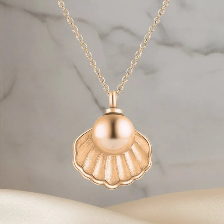 Rose gold memorial necklace featuring a scallop shell design, designed to hold human ashes with a delicate chain.