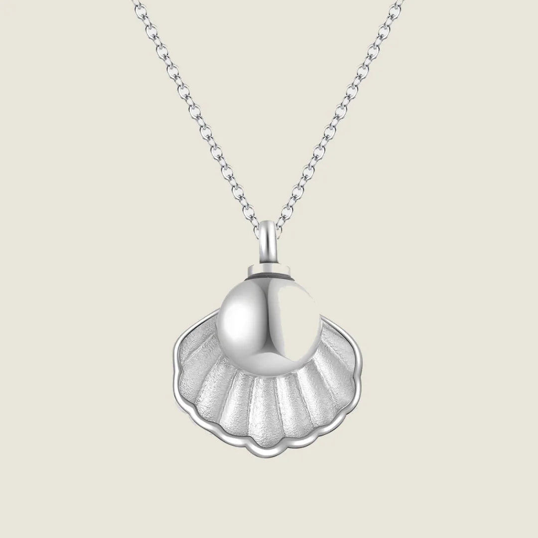 Rose gold memorial necklace pendant shaped like a seashell, designed to hold human ashes, elegantly displayed on a chain.